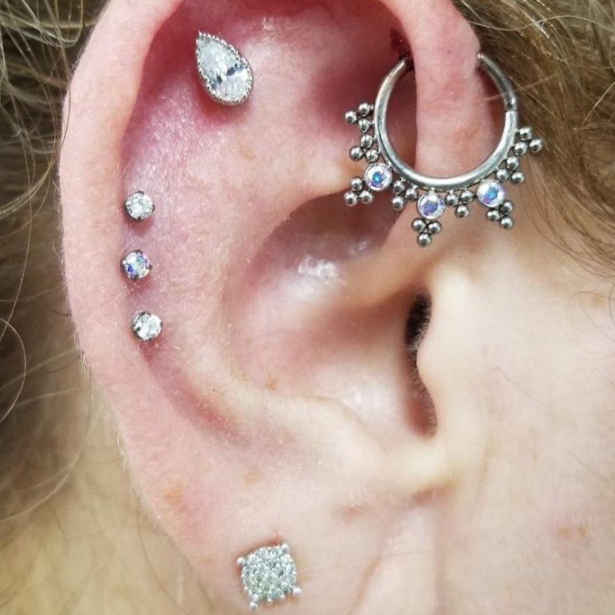 Photo of an ear with many piercings